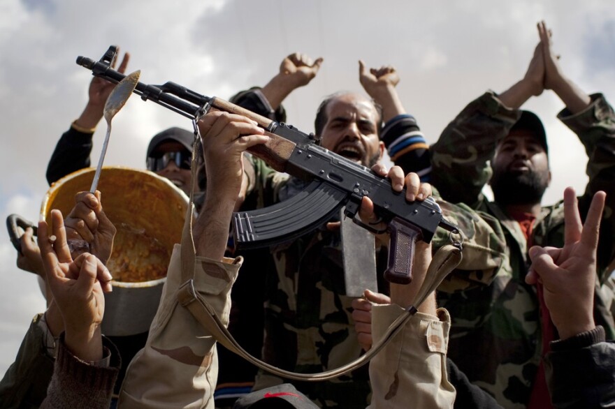 Rebels celebrate in the outskirts of Benghazi with a pot of beans left behind by Moammar Gadhafi's forces.