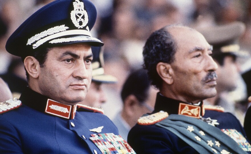 Egyptian President Anwar Sadat (right) and Mubarak are seen on the reviewing stand during a military parade on Oct. 6, 1981, just before Sadat was gunned down.