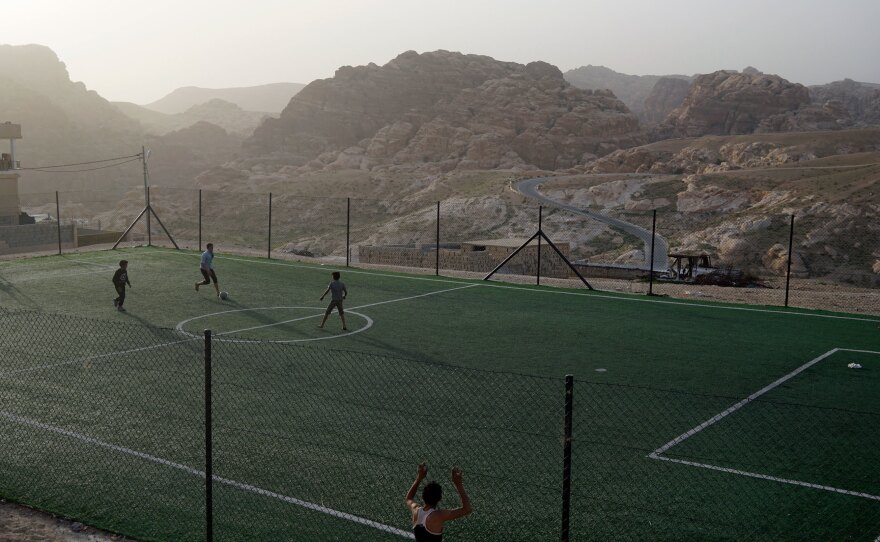 Boys play soccer on a field in the Bedouin village of Um Sayhoun, near Petra.