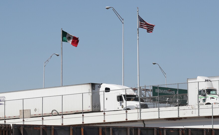 Trucks are seen heading into the United States from Mexico along the Bridge of the Americas in El Paso, Texas, on Tuesday. U.S. industries say President Trump's threatened tariffs on goods from Mexico raised uncertainty just as they were looking forward to a new trade agreement.