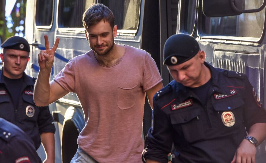 Pyotr Verzilov (center) walks to a court hearing related to Pussy Riot's rushing of the World Cup final pitch on July 15. The group suspects Verzilov was poisoned on Tuesday.