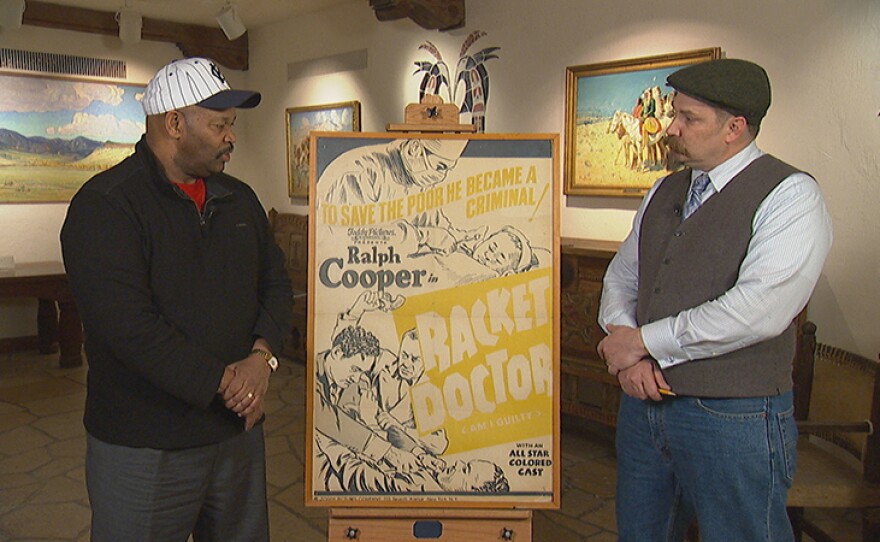 James Supp (left) appraises a "Racket Doctor" movie poster, ca. 1940 at Philbrook Museum in Tulsa, Okla.