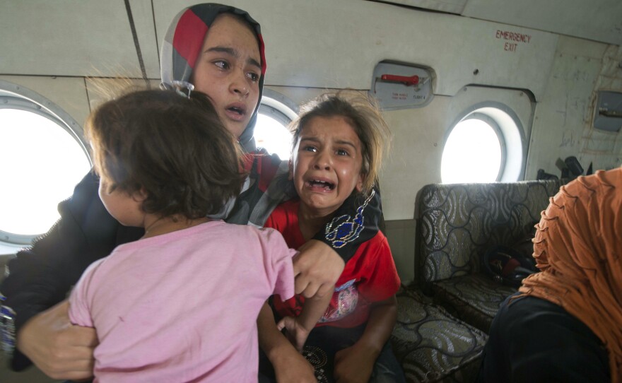 A woman and children in a military helicopter after being evacuated by Iraqi forces from Amerli, north of Baghdad late last week.