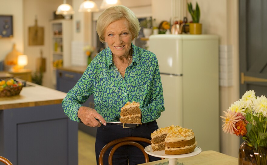 Mary Berry with Coffee Praline Cake slice.