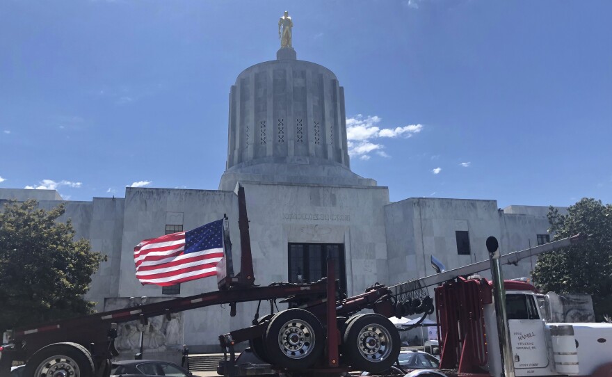 A truck moves around the Oregon state Capitol during a protest against climate bills that truckers say will put them out of business. State Senate Republicans have left the Capitol to avoid a vote on the legislation.