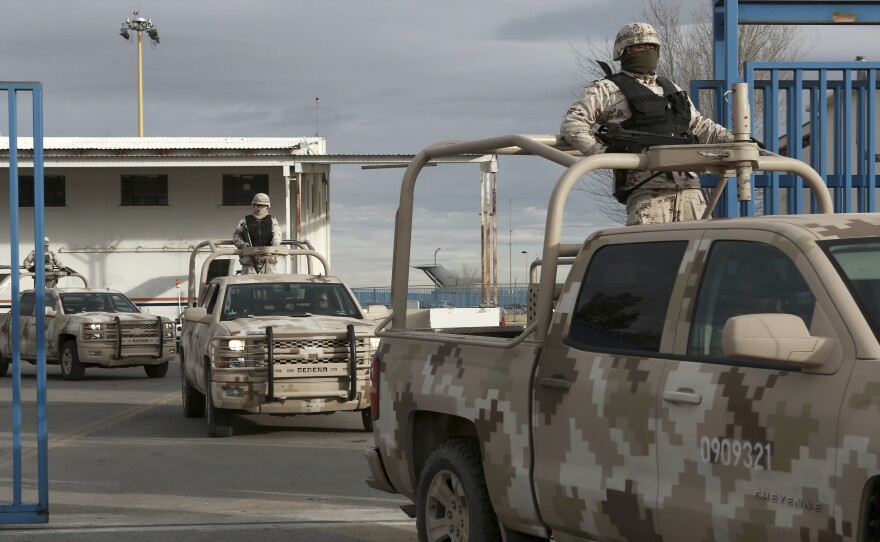 Mexican soldiers leave the airport in Ciudad Juarez, Mexico, after authorities handed over drug lord Joaquin "El Chapo" Guzman to U.S. officials.