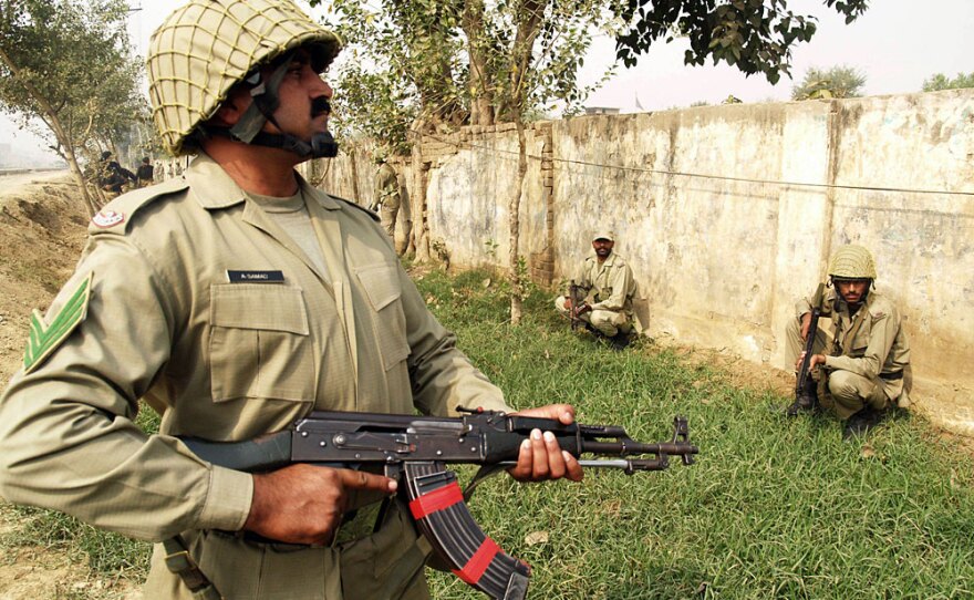 Pakistani paramilitary soldiers take position outside a police training center after gunmen attacked in Lahore on Thursday. A recent wave of attacks has raised questions about Pakistan's ability to secure its nuclear weapons facilities.