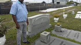 Elijah Wooten stands near the graves of many of his family members at the Westview Community Cemetery.