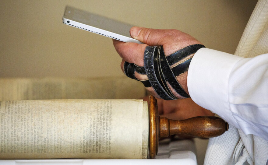 Rabbi Haim Ovadia reads the Torah to people attending a Zoom meeting of a virtual minyan from his Maryland home in 2020.