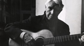 Carl Sandburg playing his guitar.