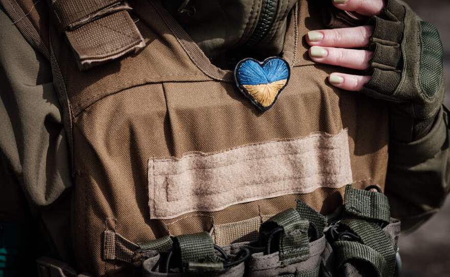 A Ukrainian soldier wears a heart-shaped Ukrainian flag given to her by a child at a checkpoint in Bakhmut, eastern Ukraine, on April 23.