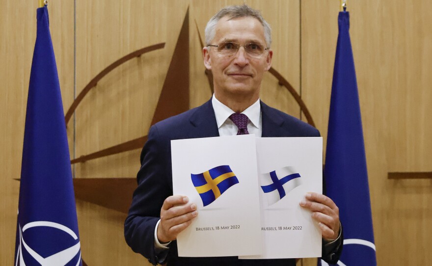 NATO Secretary-General Jens Stoltenberg displays documents as Sweden and Finland applied for membership in Brussels, Belgium, Wednesday May 18, 2022.