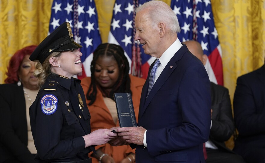 President Biden awards the Presidential Citizens Medal, the nation's second-highest civilian honor, to U.S. Capitol Police officer Caroline Edwards during a ceremony to mark the second anniversary of the Jan. 6 assault on the Capitol in the East Room of the White House on Friday.