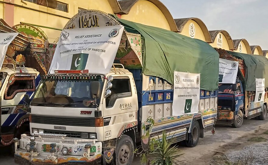 In this photo released by Pakistan's National Disaster Management Authority, a convoy of trucks carrying relief goods prepare to leave for Afghanistan at a warehouse in Islamabad, Pakistan, Thursday, June 23, 2022.