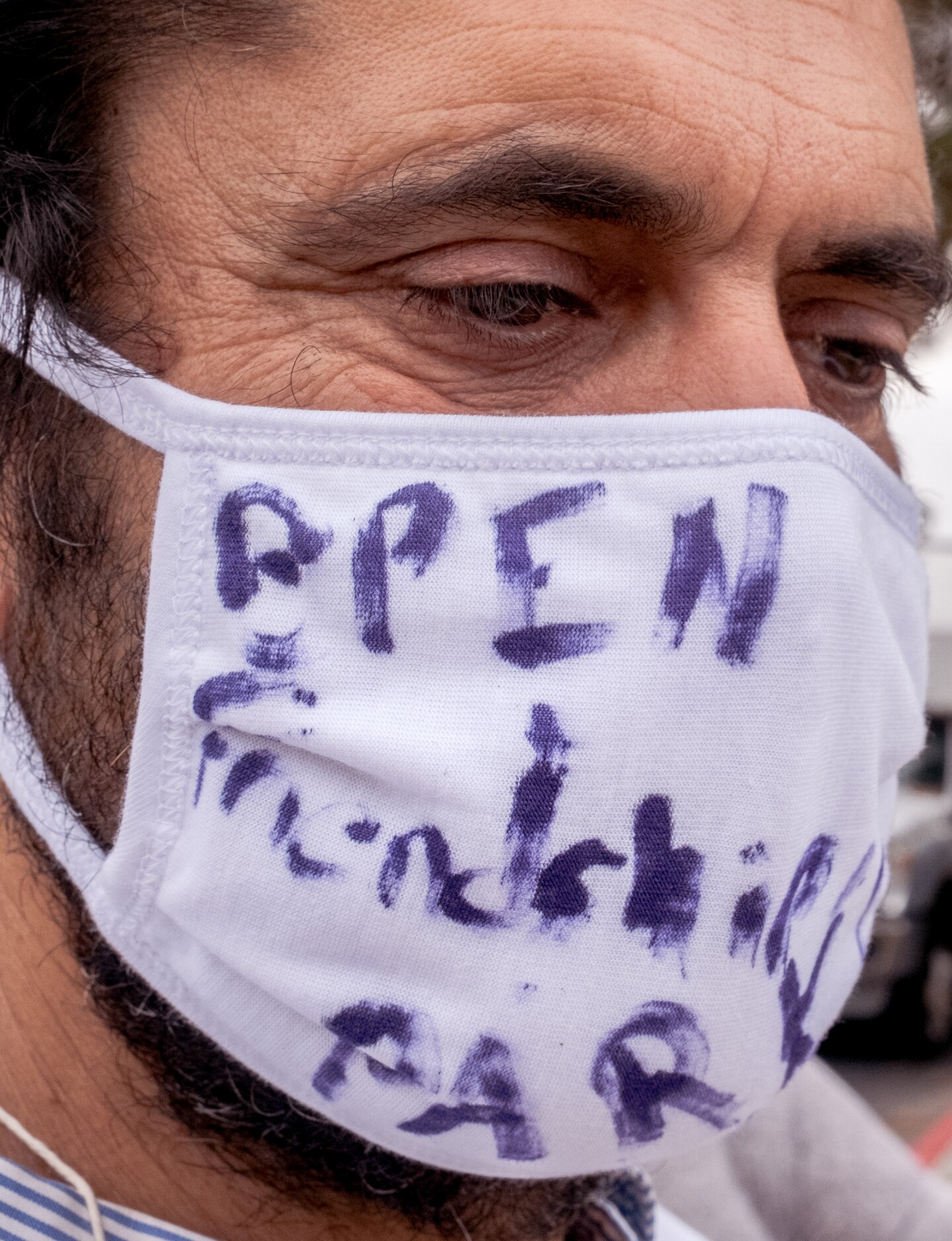Dan Watman with the Friends of Friendship Park wore a facemask calling for the reopening of Friendship Park. Chula Vista Border Patrol Station in Chula Vista, Calif. Oct. 7, 2021.
