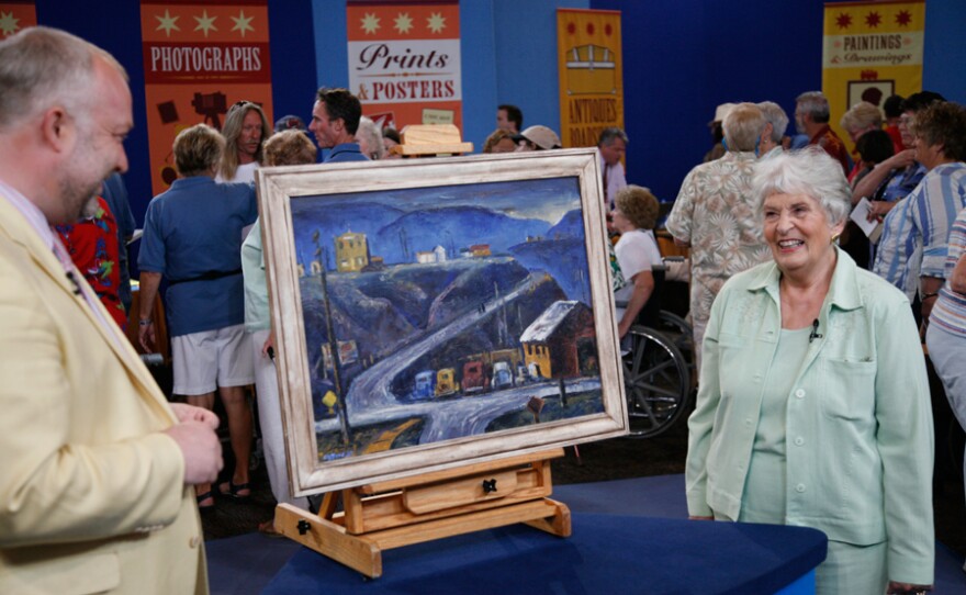 Appraiser Alasdair Nichol with a guest and her 1937 Clyfford Still oil painting.