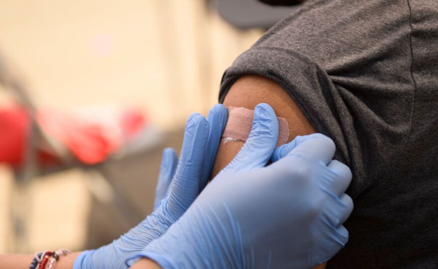 A person receives a bandage after their first dose of the Pfizer COVID-19 vaccine at a mobile vaccination clinic during a back to school event in August. Vaccines could be available for kids ages 5 to 11 as early as next week.