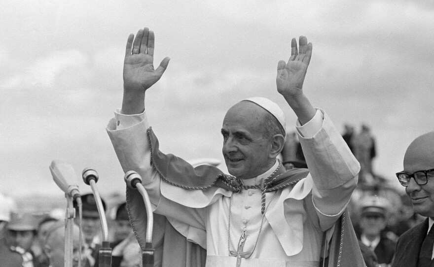 Pope Paul VI acknowledges cheers as standing on platform in Bogota, Colombia, on Aug. 22, 1968.