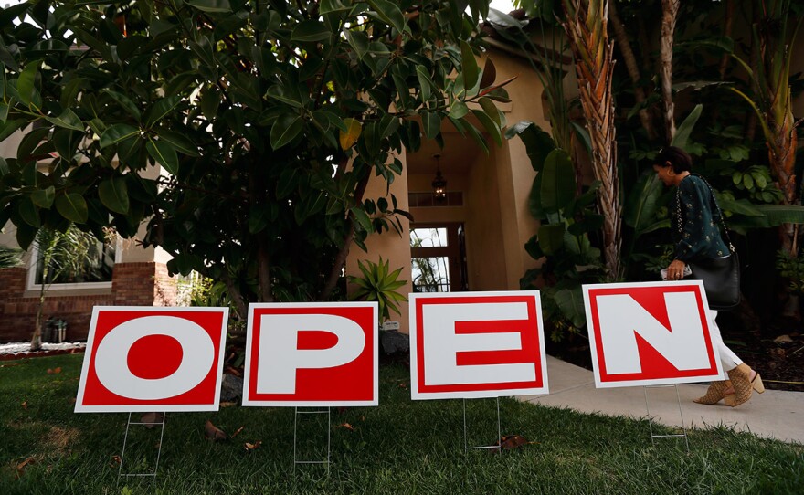 In this Oct. 3, 2018 photo, a woman arrives for an open house in Chula Vista, Calif.