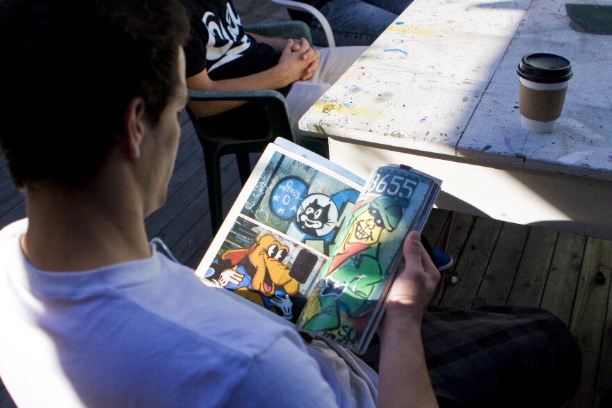 Kyle Boatwright, a.k.a Sain, looks through "Subway Art", a 1980's bible for aspiring graffiti artists.