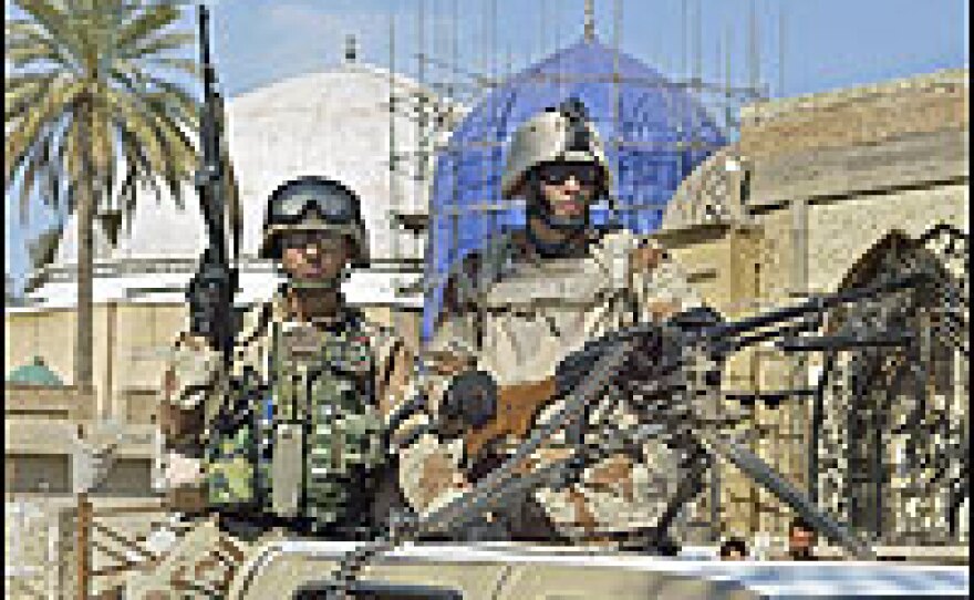 Iraqi soldiers guard a Sunni mosque in Baghdad.