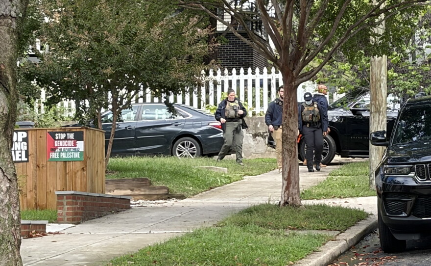 Federal agents walking away from the Washington, D.C. home of Rep. Ilhan Omar, D-Minn., on Monday morning.
