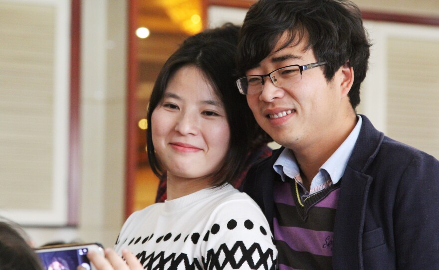 Zhang Zhaojun, 26, attends her brother's wedding with her boyfriend, Chen Ke. Zhao used to assemble computer motherboards in southern China. Now she's back home in Qichun, in Hubei province, making more money working as an accountant at a fertilizer factory.