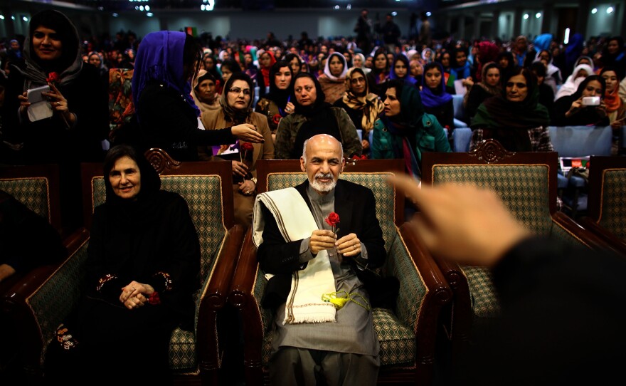 Then-presidential candidate Ashraf Ghani sits next to his wife, Rula, during a campaign rally in Kabul on March 9, 2014. In an unusual move for Afghan politics, Ghani's wife spoke during the rally â a foreshadowing of her role in her husband's presidency.