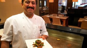 Rasika chef Vikram Sunderam, here with a towering dish of eggplant and potato, says, "Indian cuisine is a very personal cuisine. It's made from family to family, how they like to cook."