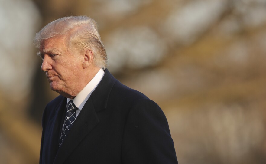 The White House announced Monday that it was expelling dozens of Russian officials from the U.S. President Trump is seen walking across the South Lawn of the White House on Sunday.