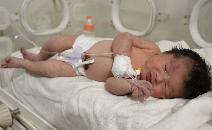 A newborn baby who was found still tied by her umbilical cord to her mother and pulled alive from the rubble of a home in northern Syria following a deadly earthquake, receives medical care at a clinic in Afrin, on Tuesday. The infant is the sole survivor of her immediate family, the rest of whom were killed when the quake flattened their home in Jindayris, cousin Khalil al-Suwadi said.