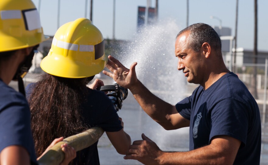 LAFD Capt. Eddie Marez instructs cadets at Banning High on how to operate a fire hose.