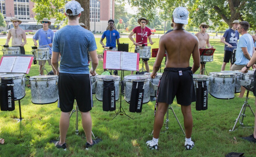 Members of Alabama's Million Dollar Band practice three times a day gearing up for football season. Like the team, the drummers keep playing until they're nearly perfect.