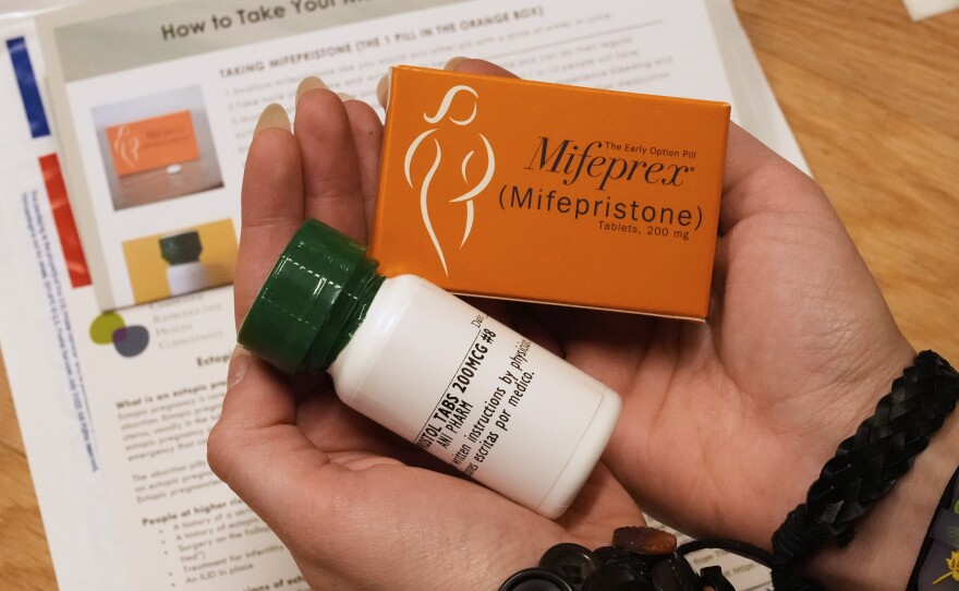 A coordinator at Massachusetts Medication Abortion Access Project shows what the medication abortion kit that is prescribed and mailed via telehealth looks like.