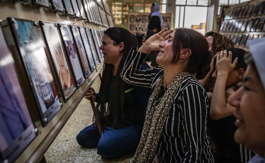 Women from Kocho village mourn family members who were among the 3,000 Yazidis killed by ISIS during a 2019 commemoration of the fifth anniversary of the start of the ISIS genocide against Yazidis. ISIS fighters shot more than 500 men and older boys in the small village.