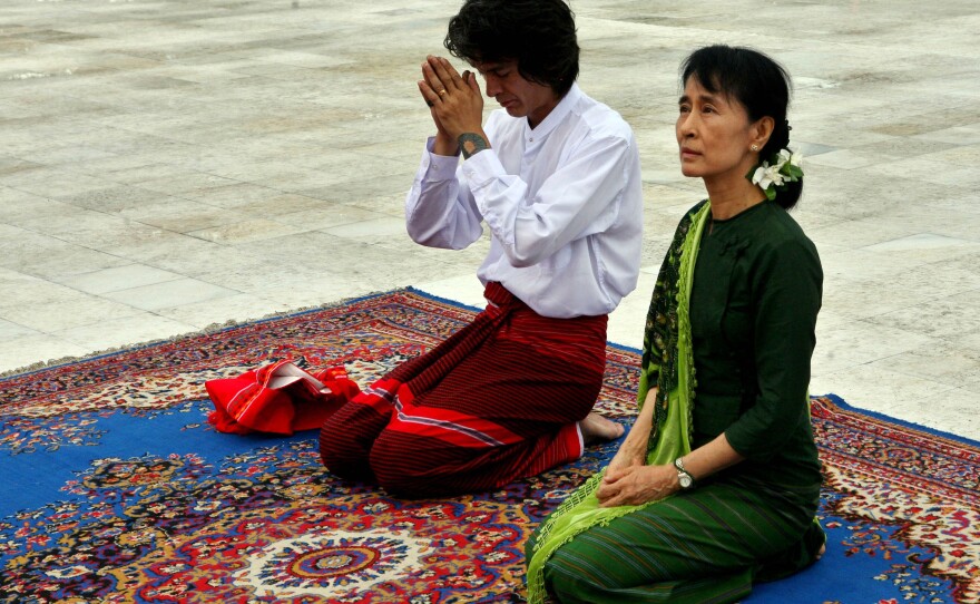 Aung San Suu Kyi, right, and her youngest son Kim Aris pay respect to the late Gen. Aung San, father of Suu Kyi, at the Martyr's Mausoleum in Yangon, Myanmar, Tuesday, July 12, 2011.