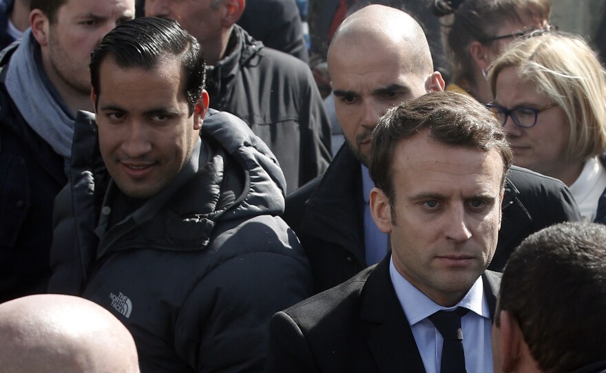 Emmanuel Macron (right) is flanked by his bodyguard, Alexandre Benalla (left) in Amiens, France. Benalla was filmed in May beating protesters during labor demonstrations.