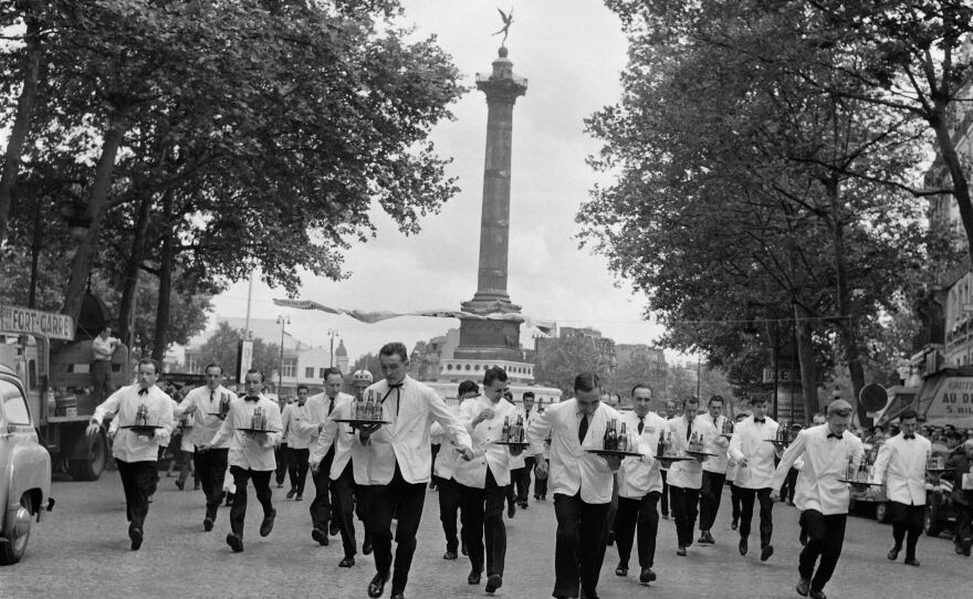 Waiters take part in the café race in 1957 at the Place de la Bastille in Paris.