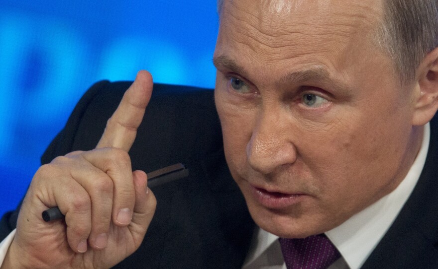 Russian President Vladimir Putin gestures during his annual news conference in Moscow, Russia, on Thursday, where he blamed Western sanctions and falling oil prices on his country's economic troubles.