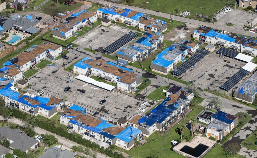 Blue tarps cover houses with damaged roofs in Lake Charles, La., after Hurricane Delta hit the city in October 2020.