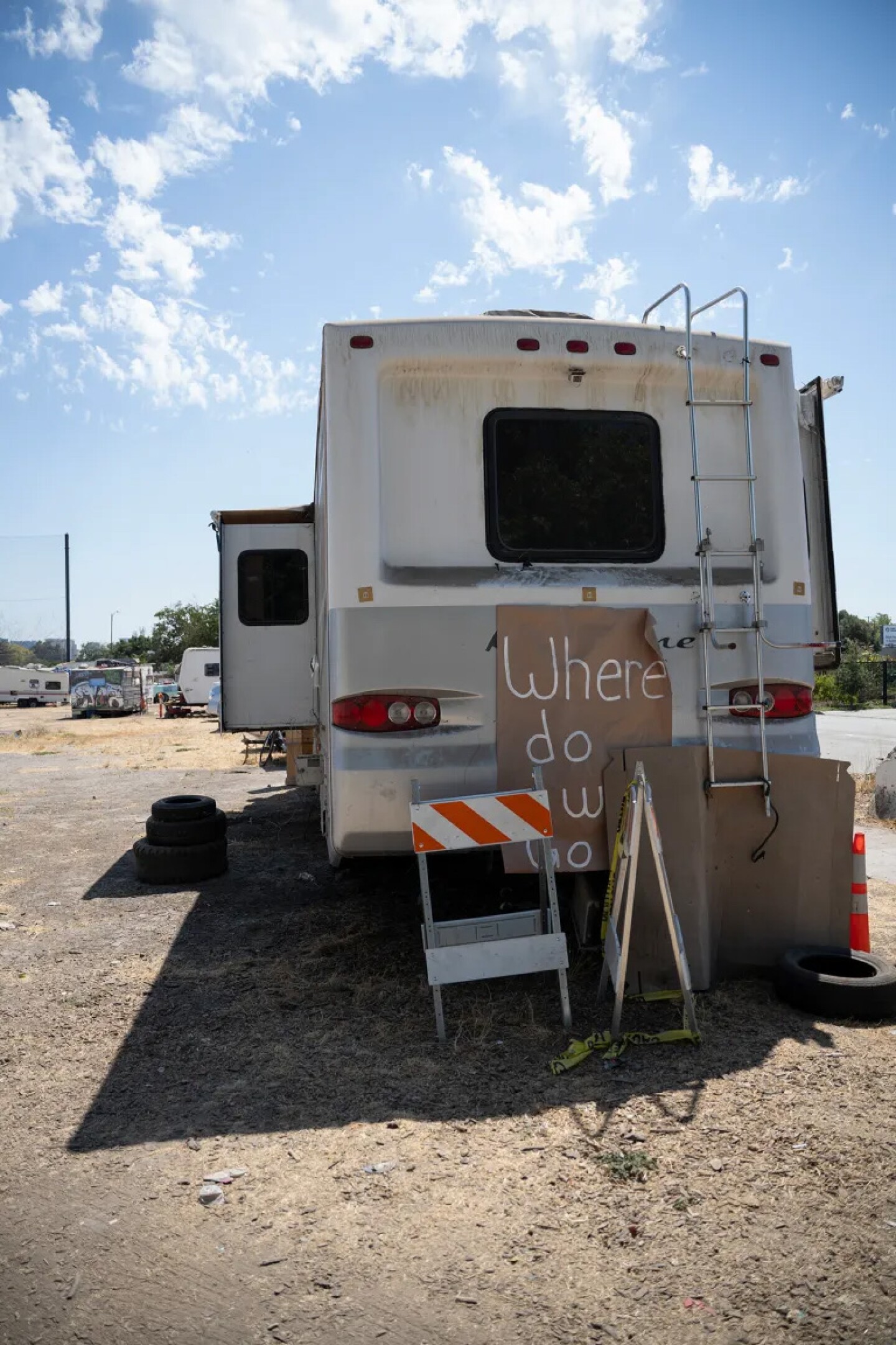 A sign reading “Where do we go?” is posted on an RV at Columbus Park, San Jose’s largest homeless encampment, on Aug. 25, 2025.