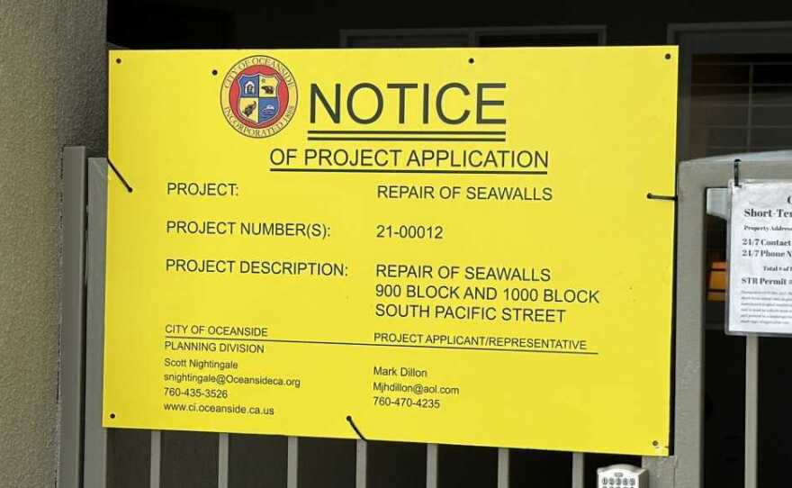 A notice of the application to repair the seawall in Oceanside posted at the gate of a home, Oct. 16, 2023..