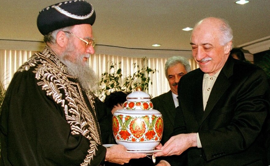 Muslim cleric Fetullah Gulen (right) receives a vase from Israel's Chief Rabbi Eliyahu Bakshi Doron during a meeting in Istanbul, Turkey, in 1998. Turkey's President Recep Tayyip Erdogan on Saturday accused Gulen of involvement in a coup attempt, a charge Gulen denied.