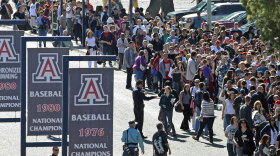 People line up to get in to a memorial service for the victims of Saturday's  shootings. The service was held at the University of Arizona campus in Tucson on Wednesday.