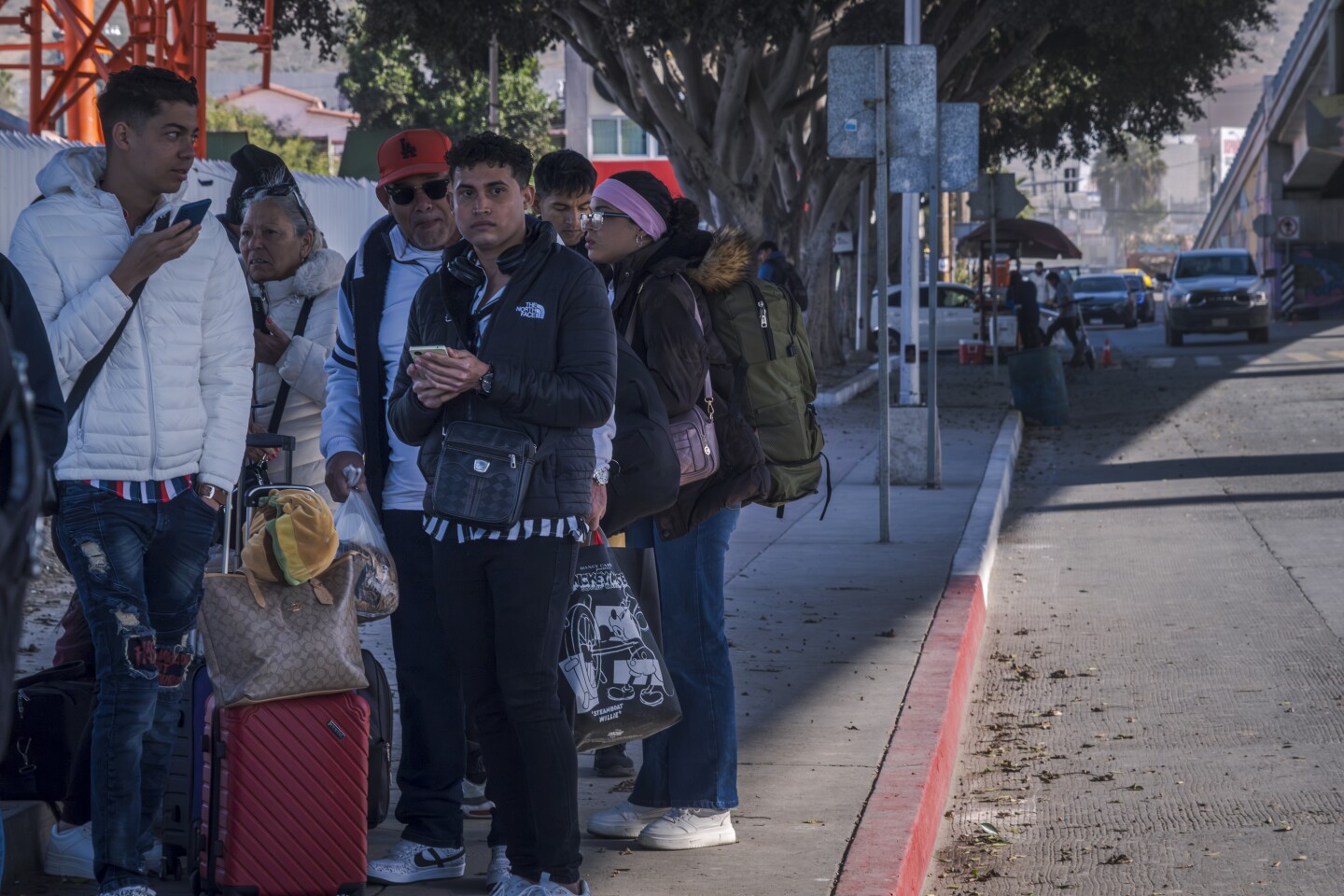 Migrants line up at the El Chaparral border crossing into the United States hoping to get answers about their asylum appointment cancellations after the American government cancels all appointments made through the CBP One app. Jan. 21, 2025 in Tijuana, Mexico.
