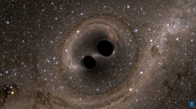 A simulated image of two black holes merging into one. 