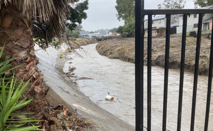 Water flowing down Chollas Creek as rain falls on Feb. 1, 2024.