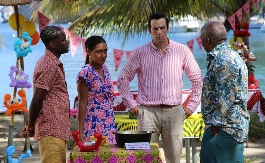 JP Hooper (TOBI BAKARE), DS Florence Cassell (JOSEPHINE JOBERT), DI Neville Parker (RALF LITTLE), Commissioner Selwyn Patterson (DON WARRINGTON) in a scene from DEATH IN PARADISE: Season 10.