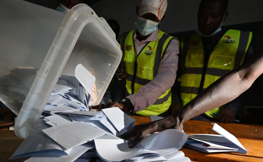 Niger's Electoral Commission workers count the ballots at a polling station during Niger's presidential election runoff in Niamey on Sunday. In the country's west, a vehicle carrying poll workers struck a landmine, killing seven and seriously wounding three others. It's unclear if the vehicle was deliberately attacked.