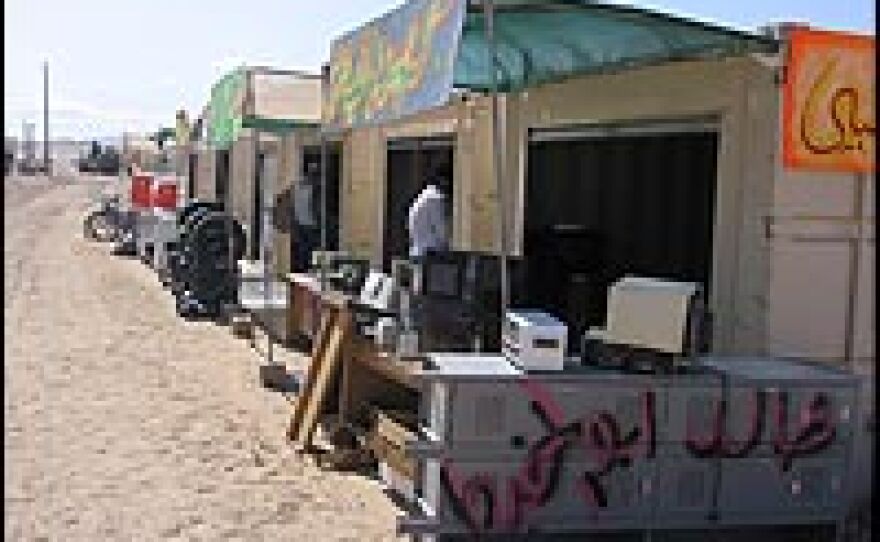 Vendor stalls in the fictional marketplace.